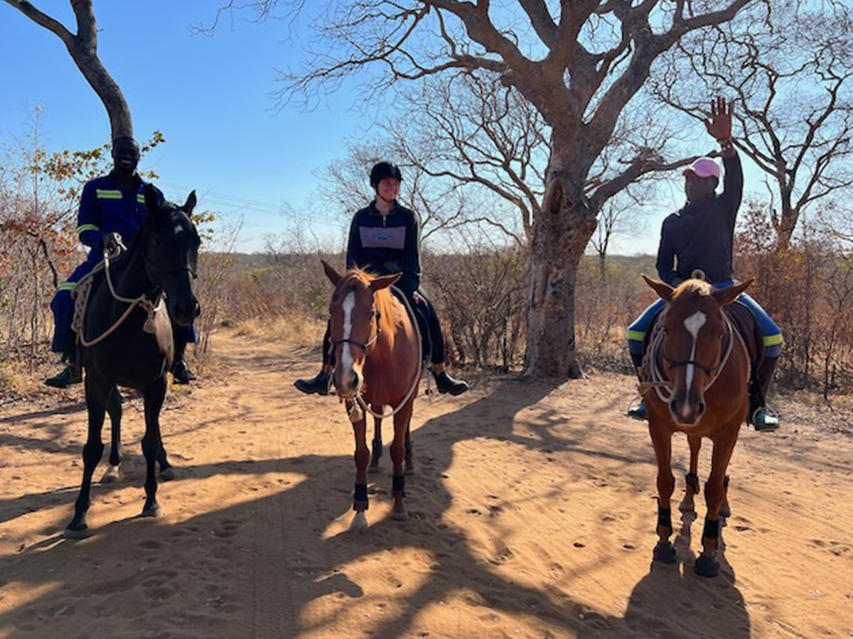 Volunteer returning from a scenic ride through the bush on horseback