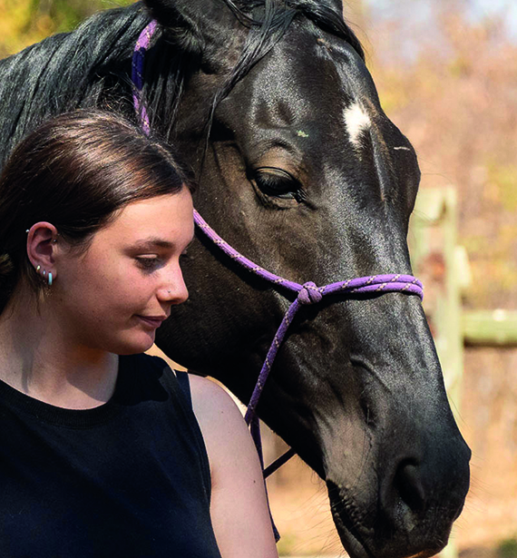 In Africa, a girl and a horse stand close, embodying a profound connection. Amidst a volunteer-run sanctuary for healing, their bond transcends words, offering solace and strength to all who witness it.